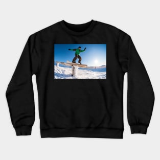 Snowboarder sliding on a rail Crewneck Sweatshirt